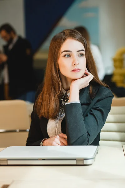 Young businesswoman on a coffee break. Using tablet computer.