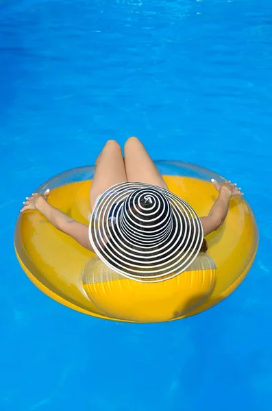 Sexy young woman with a rubber ring in the swimming pool, top vi