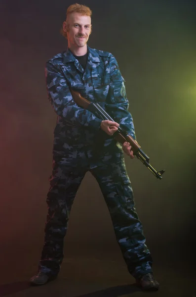 Man in camouflage clothing with a gun