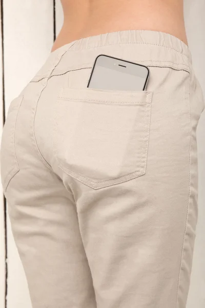 Smart phone in a pocket pants, beautiful girl with sexy booty on