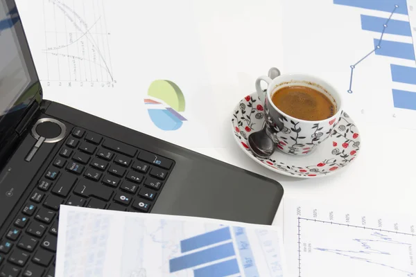 Businessman  with coffee and laptop analyzing of the  monitoring