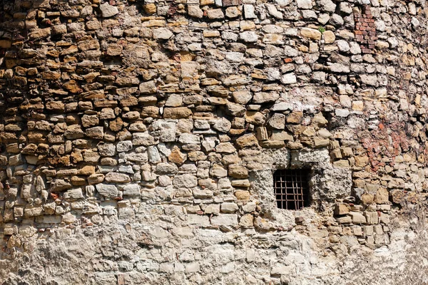 Old stone wall with window