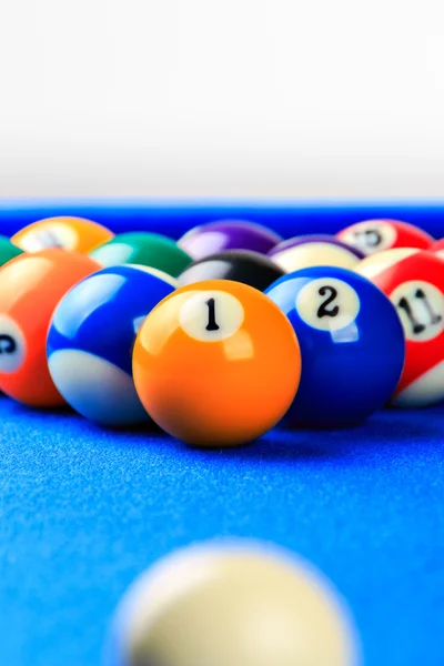 Billiard balls in a blue pool table.