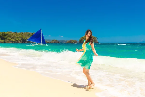Young beautiful Asian  girl on a tropical beach. Tropical sea in