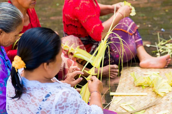 Bali, Indonesia, May 3, 2015. Balinese women make decorations of