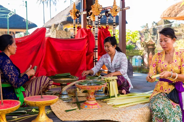 Bali, Indonesia, May 3, 2015. Balinese women make decorations