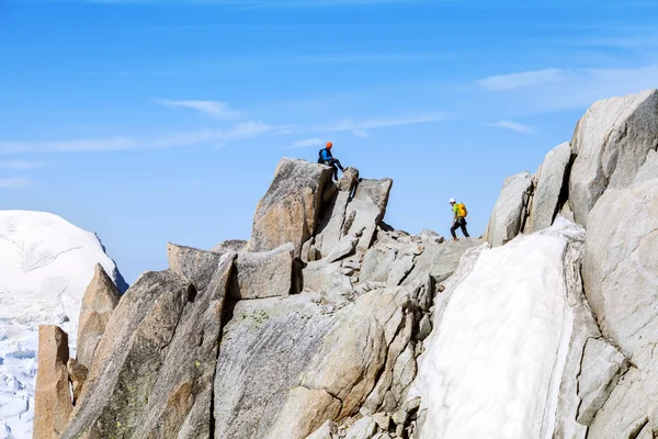 Two alpinists on top of cliff