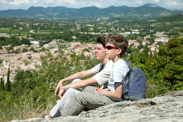 Young boy and adult man on hill