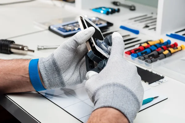 Close-up photos showing process of mobile phone repair