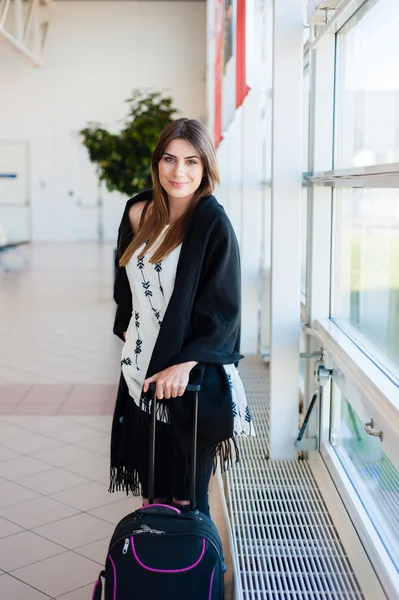 Airport Young female passenger at gate waiting in terminal while waiting for her flight