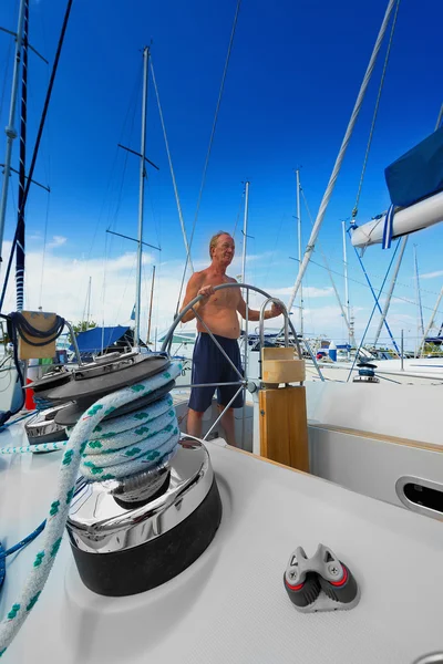 Man at the helm of sailboat