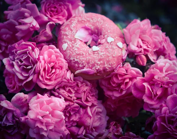 Doughnut with pink glaze and roses