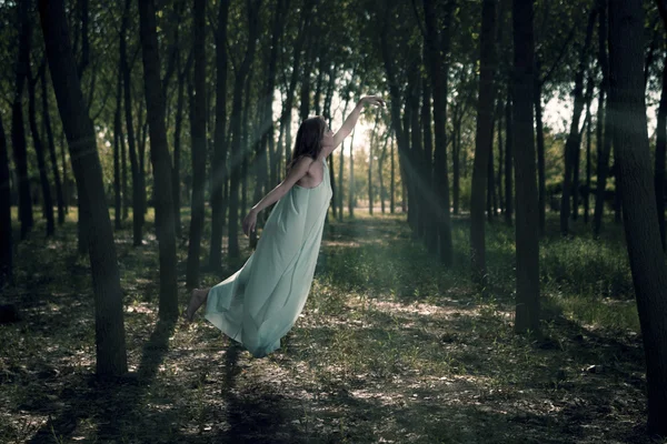 Woman flying in the woods