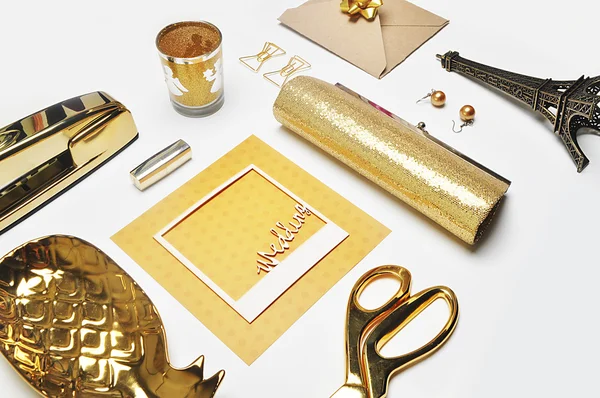 Flat lay. Woman accessories on the table, woman desk top. View top table, notebook and gold items.