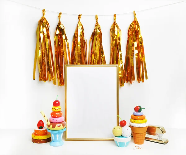 Mockup frame.Gold frame and white wall. Gold tassel and sweet bar. Ice cream, cupcakes, cherry.
