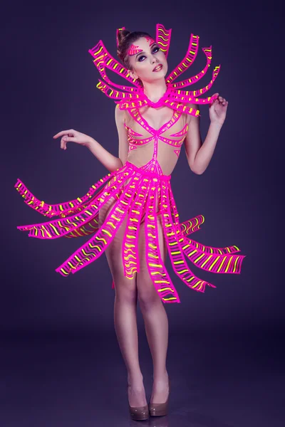 Sexy female disco dancer poses in UV costume