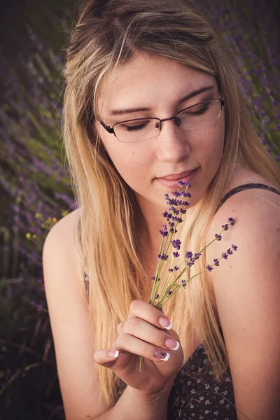Beautiful provence woman relaxing in lavender field watching on sunset. Series. alluring girl with purple lavender.