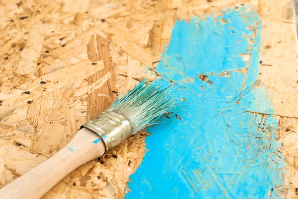 Paint brush on wooden board
