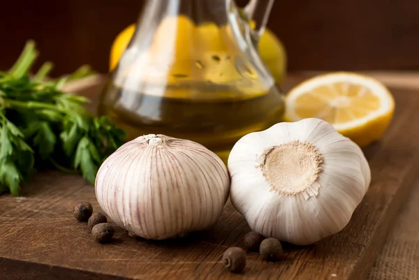 Slices of lemon, garlic cloves and parsley on white background