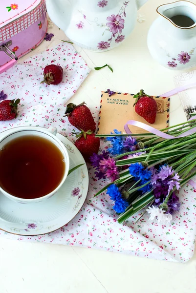 Morning tea, strawberries and a bouquet of cornflowers