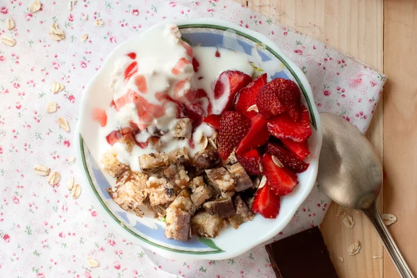 Granola with strawberries, yogurt and strawberry topping, milk j