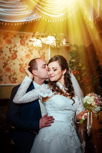 Charming bride and groom on their wedding celebration in a luxurious restaurant.