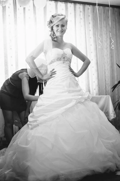 Bride getting ready. beautiful bride in white wedding dress with hairstyle and bright makeup. Happy sexy girl waiting for groom. Romantic lady in bridal dress have final preparation for wedding.