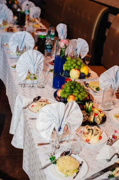 Catering table set service with silverware and glass stemware at restaurant before party