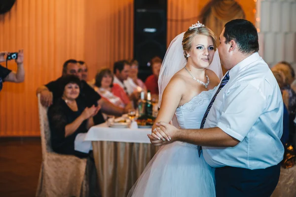 Beautiful caucasian couple just married and dancing their first dance.