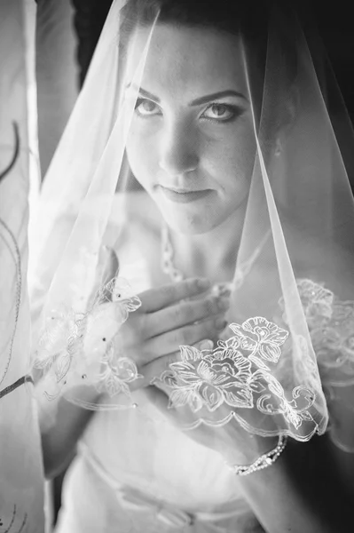 Bride getting ready. beautiful bride in white wedding dress with hairstyle and bright makeup. Happy sexy girl waiting for groom. Romantic lady in bridal dress have final preparation for wedding