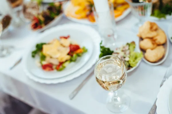 Catering table set service with silverware and glass stemware at restaurant before party.