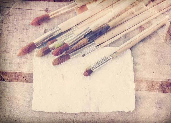 Brushes and vintage white paper