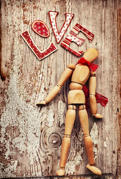 Wooden man with red bow