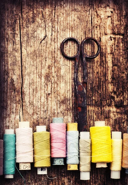 Scissors and bobbins with threads