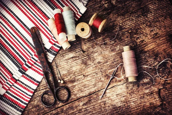 Scissors, fabric and bobbins with threads