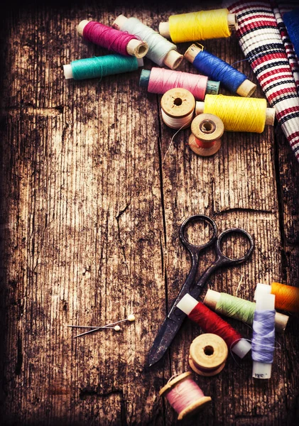 Scissors, fabric and bobbins with threads