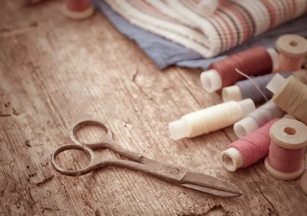 Scissors, fabric and bobbins with threads