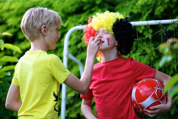 Two boys supporting Belgian football team