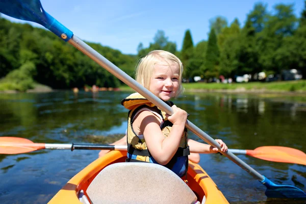 Active little girl kayaking on the river