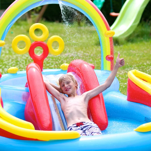 Kids splashing in inflatable swimming pool