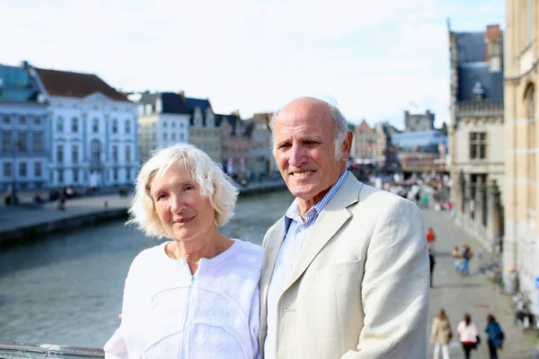 Happy senior couple traveling in Europe, enjoying city of Ghent, Belgium