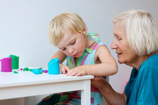 Toddler girl creating in daycare