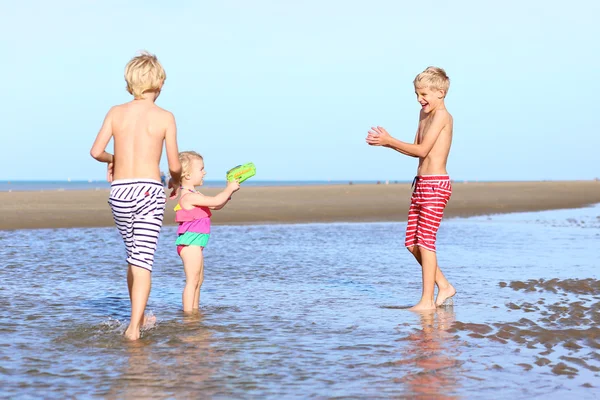 Happy kids playing on the beach