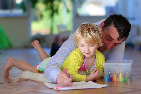 Father and daughter drawing at home