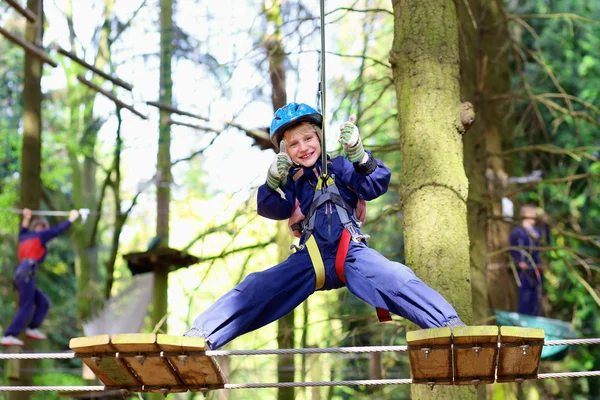 Adventurous boy climbing in the park