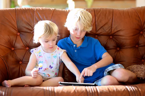 Brother and sister playing with tablet pc