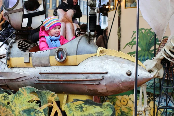 Little girl enjoying merry-go-round
