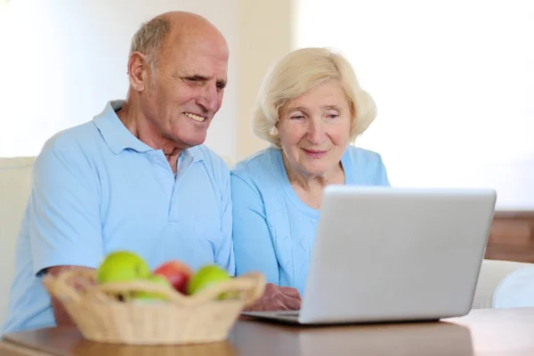 Modern senior couple relaxing at home