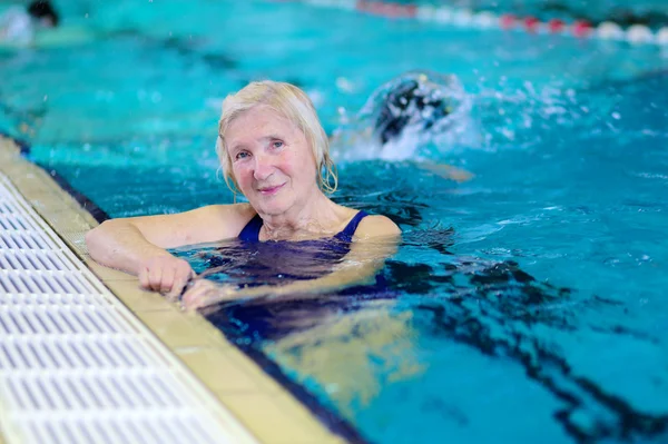Senior woman enjoying lesson in swimming pool