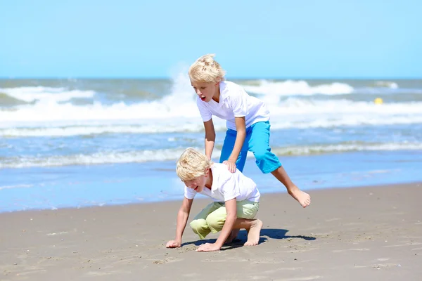 Two brothers playing on the beach